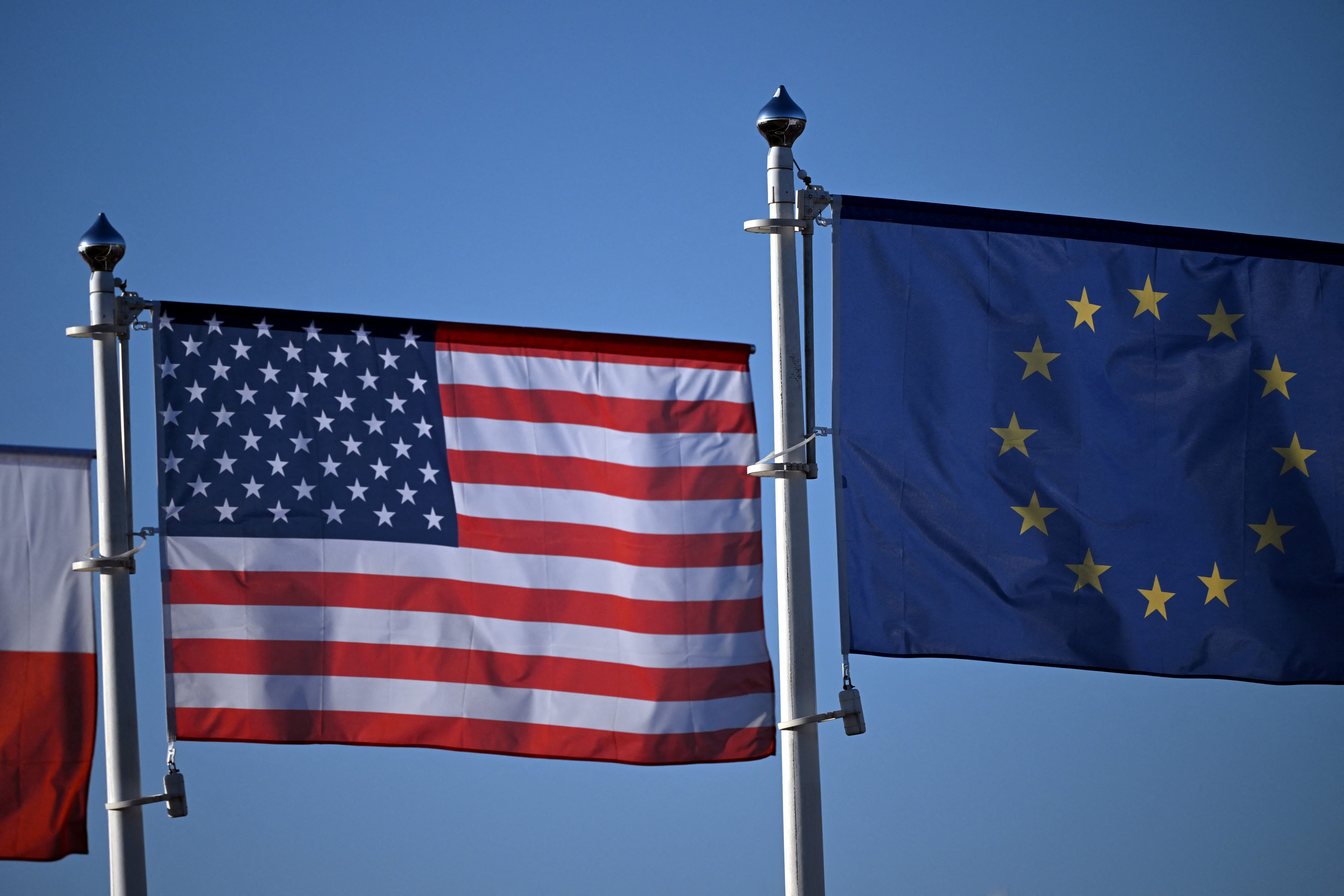 The EU and US flags flutter next to the military hub for Ukraine, in Jasionka, south-east Poland on March 6, 2025.